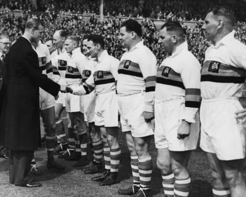 Prince Philip, the Duke of Edinburgh, shaking hands with rugby player D Ward as he meets the Bradford Northern Rugby League Team at the Cup Final at Wembley Stadium in 1949.