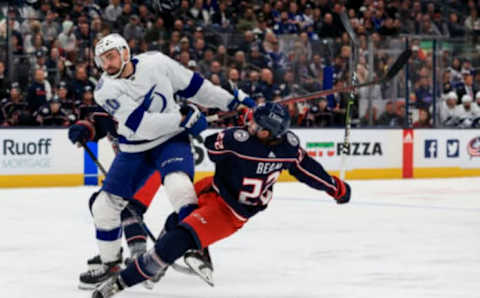 Apr 28, 2022; Columbus, Ohio, USA; Tampa Bay Lightning left wing Nicholas Paul (20) checks Columbus Blue Jackets defenseman Jake Bean (22) in the third period at Nationwide Arena. Mandatory Credit: Aaron Doster-USA TODAY Sports