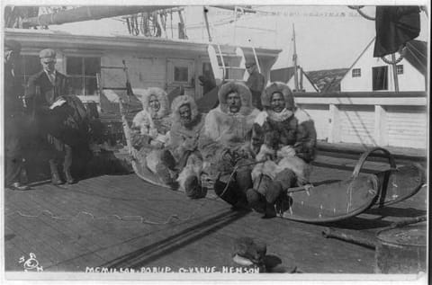 (L-R) Donald Baxter MacMillan, George Borup, the Roosevelt's first mate Thomas Gushue, and Matthew Henson sit on the sledge that went to the North Pole.