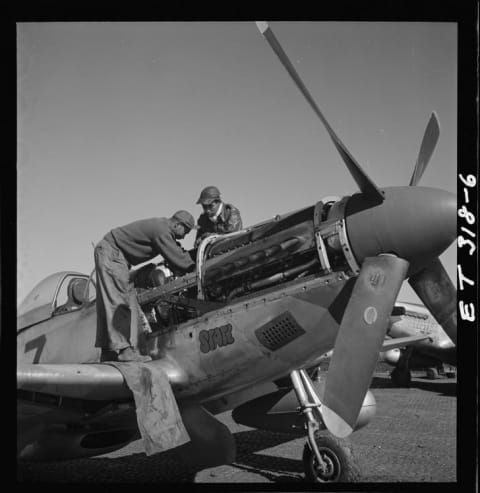 Tuskegee Airmen Marcellus G. Smith (left) and Roscoe C. Brown work on a plane nicknamed Tootsie in Ramitelli, Italy, in March 1945.