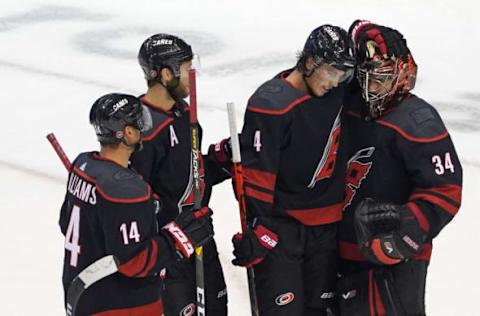 Petr Mrazek #34 of the Carolina Hurricanes, Haydn Fleury #4 and Justin Williams #14 celebrate  (Photo by Andre Ringuette/Freestyle Photo/Getty Images)