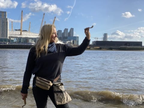 Mudlark Nicola White holds a pipe she found on the Thames foreshore.