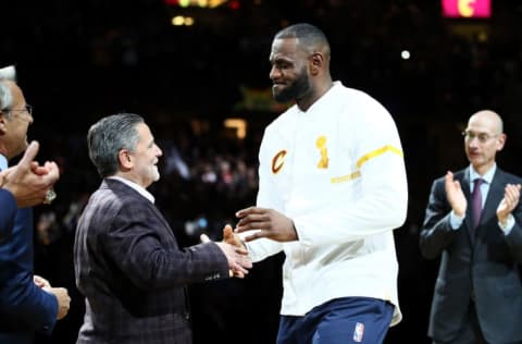 LeBron James looks down on Dan Gilbert as he claims his NBA championship ring in 2016.