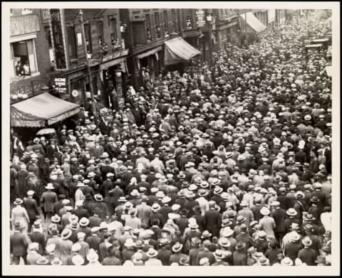 A huge crowd joins Sacco and Vanzetti's funeral procession on Hanover Street in Boston.