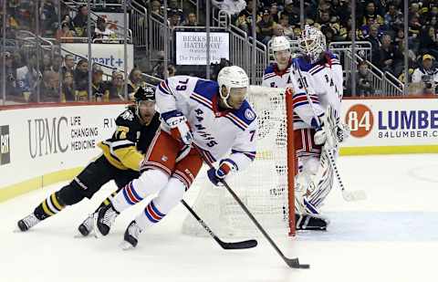 Feb 26, 2022; Pittsburgh, Pennsylvania, USA; New York Rangers defenseman K’Andre Miller (79) skates with the puck from behind the net as Pittsburgh Penguins center Jeff Carter (77) chases during the third period at PPG Paints Arena. The Penguins shutout the Rangers 1-0. Mandatory Credit: Charles LeClaire-USA TODAY Sports