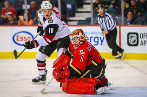 Oct 5, 2016; Calgary, Alberta, CAN; Calgary Flames goalie Brian Elliott (1) makes a save as Arizona Coyotes center Christian Dvorak (18) tries to score during the second period during a preseason hockey game at Scotiabank Saddledome. Mandatory Credit: Sergei Belski-USA TODAY Sports