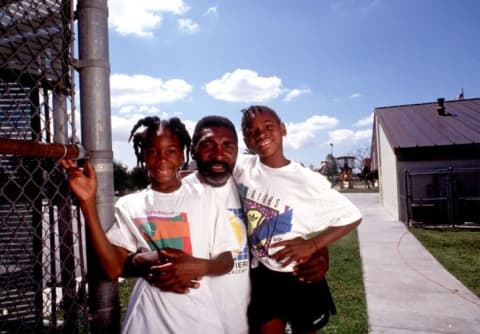 L to R: Venus, Richard, and Serena Williams pose near their home in Compton, California in 1991.