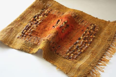 Handwoven, handspun recycled sari silk with vetiver scented wax beads.