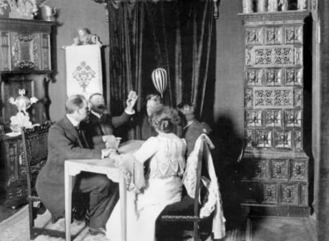 Medium Eusapia Palladino (woman in the background) during a seance at the home of Baron von Schrenck Notzing.