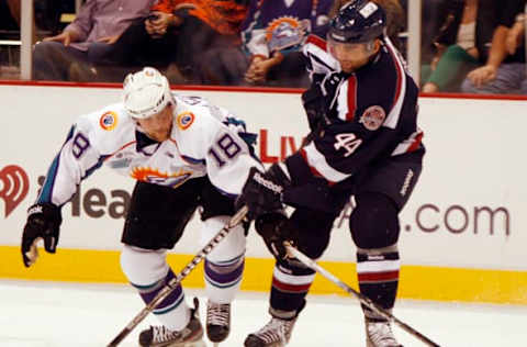 Orlando’s Rob Mignardi (18) and South Carolina’s Tommy Cross (44) battle for the puck during the South Carolina Stingrays at Orlando Solar Bears ECHL hockey game at the Amway Center on Thursday, October 25, 2012, in Orlando, Florida. (Stephen M. Dowell/Orlando Sentinel/MCT via Getty Images)