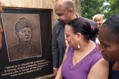 Daniel Duster (L) and Michelle Duster (C) attend the dedication ceremony for the monument to their great-grandmother Ida B. Wells on June 30, 2021.