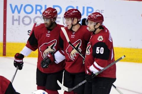 Mar 22, 2016; Glendale, AZ, USA; Arizona Coyotes left wing Alex Tanguay (40) celebrates with center Antoine Vermette (50) and left wing Anthony Duclair (10) after scoring a goal in the first period at Gila River Arena. Mandatory Credit: Matt Kartozian-USA TODAY Sports