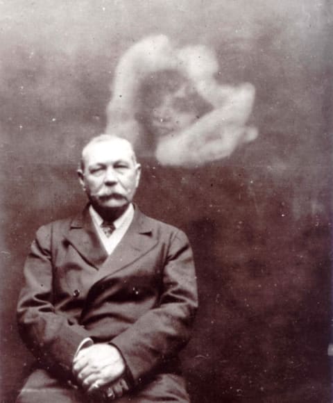 Arthur Conan Doyle poses in a Victorian "spirit photograph."