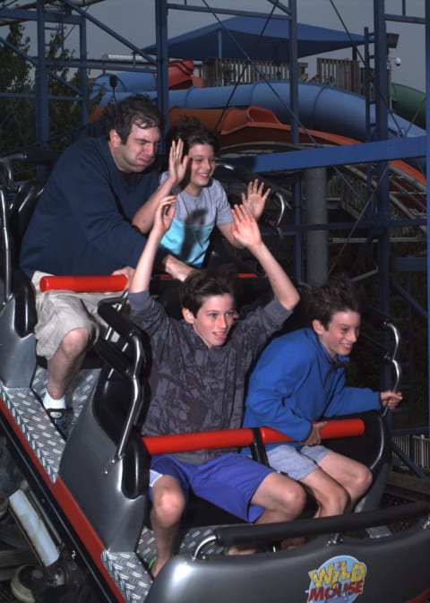 Author A.J. Jacobs and his kids "enjoying" a roller coaster.