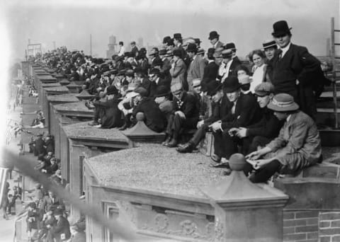 Fans watch a baseball game at Philadelphia’s Shibe Park from the rooftops across the street on North 20th street.