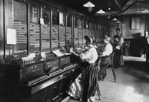 Operators at the switchboard of the Magneto Exchange of the National Telephone Company.