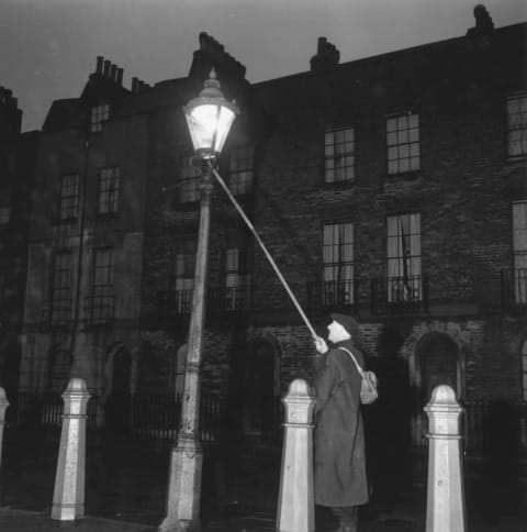 London's oldest lamplighter John Jennings extinguishing a lamp in Clerkenwell at 4.45 am.