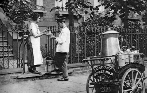 A milkman delivering milk to a North London resident, circa 1926-1927.