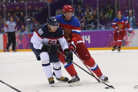 Feb 16, 2014; Sochi, RUSSIA; Slovakia forward Marcel Hossa (88) and Russia defenseman Ilya Nikulin (5) in a men’s preliminary round ice hockey game during the Sochi 2014 Olympic Winter Games at Bolshoy Ice Dome. Mandatory Credit: Winslow Townson-USA TODAY Sports