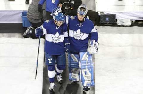 Jan 1, 2017; Toronto, Ontario, CAN; Toronto Maple Leafs center Auston Matthews (34) is congratulated by goalie Frederik Andersen (21) as they walk off the field after scoring the game-winning goal in overtime against the Detroit Red Wings during the Centennial Classic ice hockey game at BMO Field. The Maple Leafs beat the Red Wings 5-4 in overtime. Mandatory Credit: Tom Szczerbowski-USA TODAY Sports