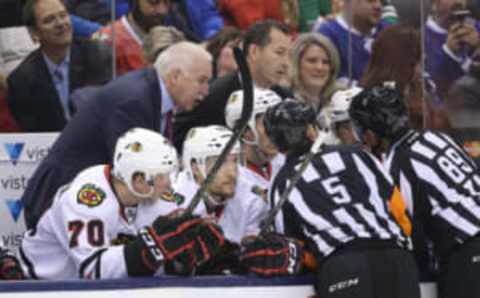 Chicago Blackhawks head coach Joel Quenneville gets an explanation from the officials about a disallowed goal by the Blackhawks in the first period as assistant coach Kevin Dineen looks on (Tom Szczerbowski-USA TODAY Sports)