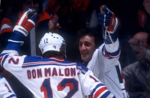 NEW YORK, NY – 1980: Phil Esposito #77 of the New York Rangers celebrates with teammate Don Maloney #12 during an NHL game circa 1980 at Madison Square Garden in New York, New York. (Photo by Bruce Bennett Studios/Getty Images)