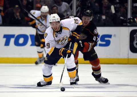 Nashville Predators center Calle Jarnkrok (19) and Anaheim Ducks defenseman Hampus Lindholm (47) battle for the puck. Mandatory Credit: Kirby Lee-USA TODAY Sports