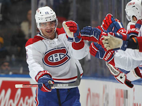 TORONTO, CANADA – OCTOBER 11: Alex Newhook #15 of the Montreal Canadiens skates by the team bench and celebrates with teammates after scoring a goal against the Toronto Maple Leafs during the second period of an NHL game at Scotiabank Arena on October 11, 2023 in Toronto, Ontario, Canada. (Photo by Claus Andersen/Getty Images)