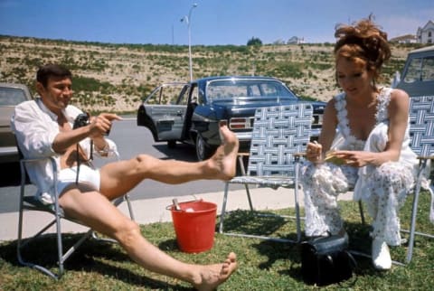 George Lazenby and Diana Rigg relax on the set of the On Her Majesty's Secret Service (1969).