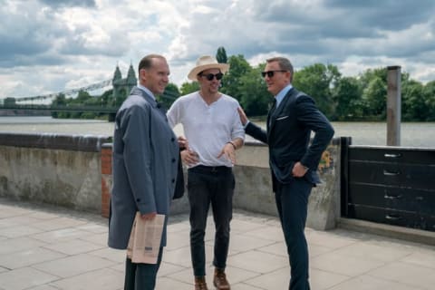 Ralph Fiennes, director Cary Joji Fukunaga, and Daniel Craig on the set of No Time to Die (2021).