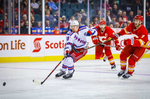 Nov 12, 2016; Calgary, Alberta, CAN; New York Rangers right wing Michael Grabner (40) and Calgary Flames defenseman TJ Brodie (7) battle for the puck during the third period at Scotiabank Saddledome. New York Rangers won 4-1. Mandatory Credit: Sergei Belski-USA TODAY Sports