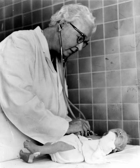 Virginia Apgar examining a newborn baby.