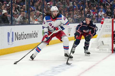 COLUMBUS, OHIO – APRIL 08: Mika Zibanejad #93 of the New York Rangers skates with the puck while Gavin Bayreuther #15 of the Columbus Blue Jackets defends during the first period at Nationwide Arena on April 08, 2023 in Columbus, Ohio. (Photo by Jason Mowry/Getty Images)