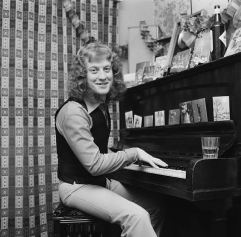 Slade singer/guitarist Noddy Holder sits at his festively decorated piano in 1973.