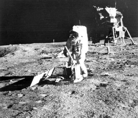 Buzz Aldrin sets up an experiment on the moon's surface during the Apollo 11 mission.