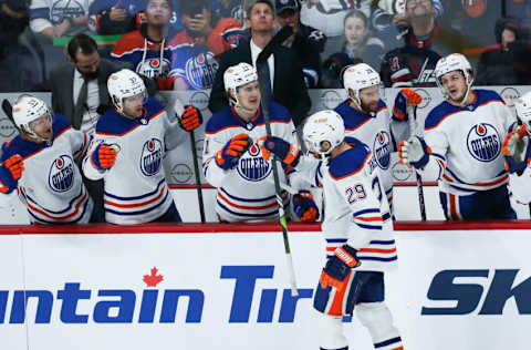 Nov 30, 2023; Winnipeg, Manitoba, CAN; Edmonton Oilers forward Leon Draisaitl (29) is congratulated by his team mates on his goal against the Winnipeg Jets during the third period at Canada Life Centre. Mandatory Credit: Terrence Lee-USA TODAY Sports