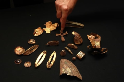 Treasures are displayed as part of the the Staffordshire Hoard, the UK's largest collection of Anglo-Saxon treasure ever found, at Birmingham Museum. The haul of over 1500 gold and silver artifacts were found in a field by metal detector enthusiast Terry Herbert.