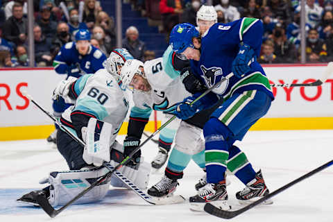 Feb 21, 2022; Vancouver, British Columbia, CAN; Seattle Kraken goalie Chris Driedger (60) makes a save as Vancouver Canucks forward Brock Boeser (6) battles for the rebound with defenseman Mark Giordano (5) in the third period at Rogers Arena. Canucks won 5-2. Mandatory Credit: Bob Frid-USA TODAY Sports