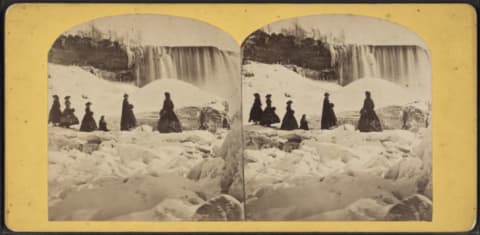 Group of women standing on the ice bridge beneath the American Falls, circa 1870.