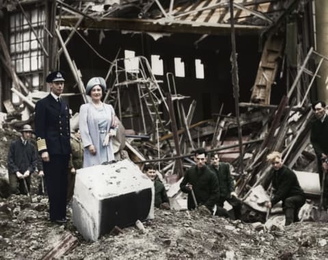 The King and Queen survey bomb damage at Buckingham Palace. The bombing destroyed the palace chapel.