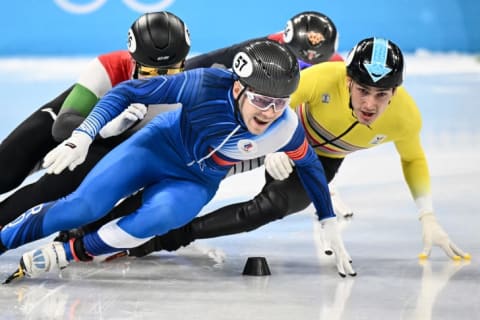 Stijn Desmet (in yellow) going sans-eyewear for the men's 1500-meter short-track final B in Beijing.