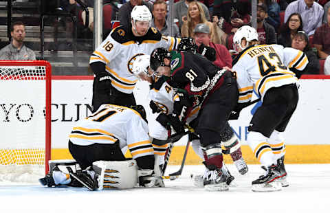 GLENDALE, ARIZONA – OCTOBER 05: Goalie Jaroslav Halak #41 of the Boston Bruins covers the puck as Phil Kessel #81 of the Arizona Coyotes and Matt Grzelcyk #48 of the Bruins battle in front of the net during the third period at Gila River Arena on October 05, 2019 in Glendale, Arizona. (Photo by Norm Hall/NHLI via Getty Images)