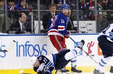 NEW YORK, NEW YORK – FEBRUARY 20: Alexis Lafreniere #13 of the New York Rangers trips up Nikolaj Ehlers #27 of the Winnipeg Jets during the third period at Madison Square Garden on February 20, 2023, in New York City. The Jets defeated the Rangers 4-1. (Photo by Bruce Bennett/Getty Images)