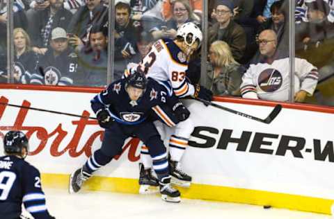 WINNIPEG, MB October 16: Winnipeg Jets forward Nikolaj Ehlers (27) boards Edmonton Oilers defenseman Matthew Benning (83) during the Winnipeg Jets and the Edmonton Oilers game on October 16, 2018 at the Bell MTS Place in Winnipeg MB. (Photo by Terrence Lee/Icon Sportswire via Getty Images)