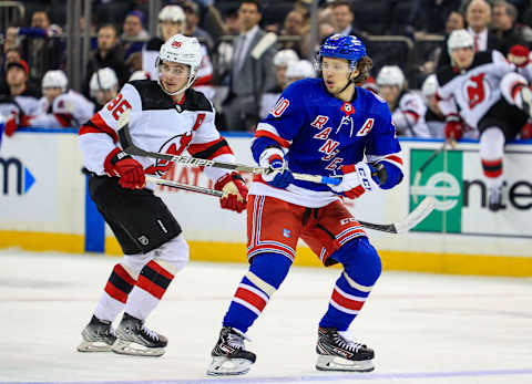 Mar 4, 2022; New York, New York, USA; New York Rangers left wing Artemi Panarin (10) and New Jersey Devils center Jack Hughes (86) look for the puck during the third period at Madison Square Garden. Mandatory Credit: Danny Wild-USA TODAY Sports