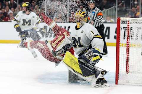 BOSTON, MASSACHUSETTS – APRIL 07: Ryan Barrow #18 of the Denver Pioneers collides with Erik Portillo #1 of the Michigan Wolverines during overtime of the Frozen Four semifinal game between the Michigan Wolverines and Denver Pioneers at TD Garden on April 07, 2022 in Boston, Massachusetts. The Pioneers defeat the Wolverines 3-2. (Photo by Maddie Meyer/Getty Images)