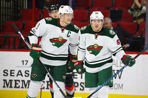 Mar 16, 2017; Raleigh, NC, USA; Minnesota Wild forward Mikael Granlund (64) celebrates his goal with forward Mikko Koivu (9) against the Carolina Hurricanes at PNC Arena. The Carolina Hurricanes defeated the Minnesota Wild 3-1. Mandatory Credit: James Guillory-USA TODAY Sports