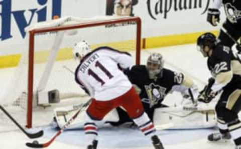 Apr 19, 2014; Pittsburgh, PA, USA; Columbus Blue Jackets left wing Matt Calvert (11) scores the game winning goal against Pittsburgh Penguins goalie Marc-Andre Fleury (29) in double overtime. Mandatory Credit: Charles LeClaire-USA TODAY Sports