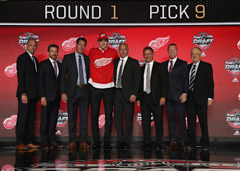 CHICAGO, IL – JUNE 23: (L-R) Head coach Jeff Blashill, assistant general manager Ryan Martin, chief amateur scout Jeff Finley, ninth overall pick Michael Rasmussen, director of amateur scouting Tyler Wright, general manager Ken Holland, assistant to the general manager Kris Draper and SVP Jim Devellano of the Detroit Red Wings pose for a photo onstage during Round One of the 2017 NHL Draft at United Center on June 23, 2017 in Chicago, Illinois. (Photo by Dave Sandford/NHLI via Getty Images)