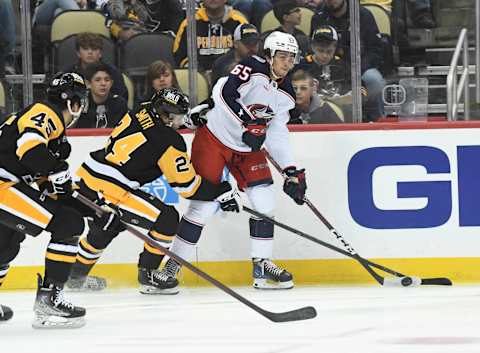 Sep 25, 2022; Pittsburgh, Pennsylvania, USA; Columbus Blue Jackets center Luca Del Bel Belluz (65) moves the puck away from Pittsburgh Penguins defenseman Ty Smith (24) and forward Jonathan Gruden (45) during the first period at PPG Paints Arena. Mandatory Credit: Philip G. Pavely-USA TODAY Sports